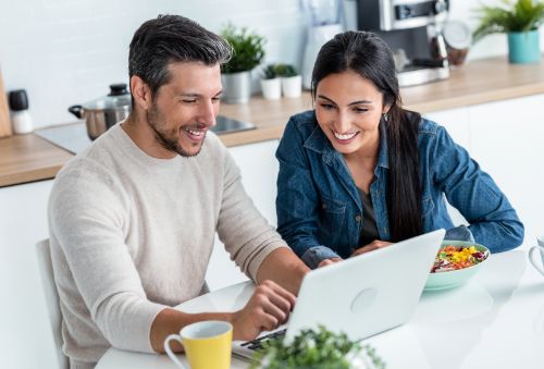 Couple managing their account on a laptop